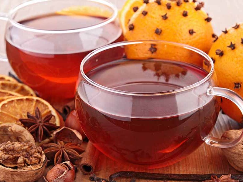 Herbal tea with sliced oranges, walnuts and star anise